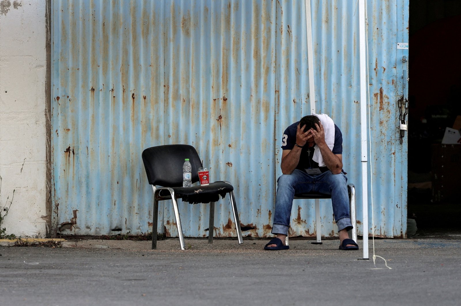 A rescued migrant reacts outside a warehouse used as a shelter, Kalamata, Greece, June 15, 2023. (Reuters Photo)