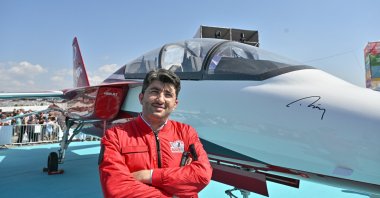 Ali Ekşi, a board member at TOMTAŞ Aviation and Technology, poses next to a Hürjet aircraft during Teknofest, Izmir, western Türkiye, Oct. 1, 2023. (AA Photo)
