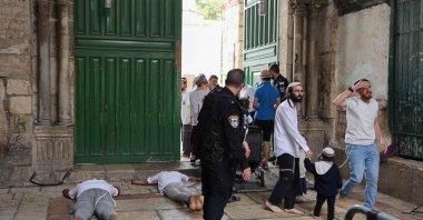 Jewish men prostrate on the ground in prayer outside the gate after a visit to the Haram al-Sharif (The Noble Sanctuary), (also known as Temple Mount) at one of the entrances of the al-Aqsa Mosque compound in the old city of Jerusalem, Oct. 2, 2023. (AFP Photo)