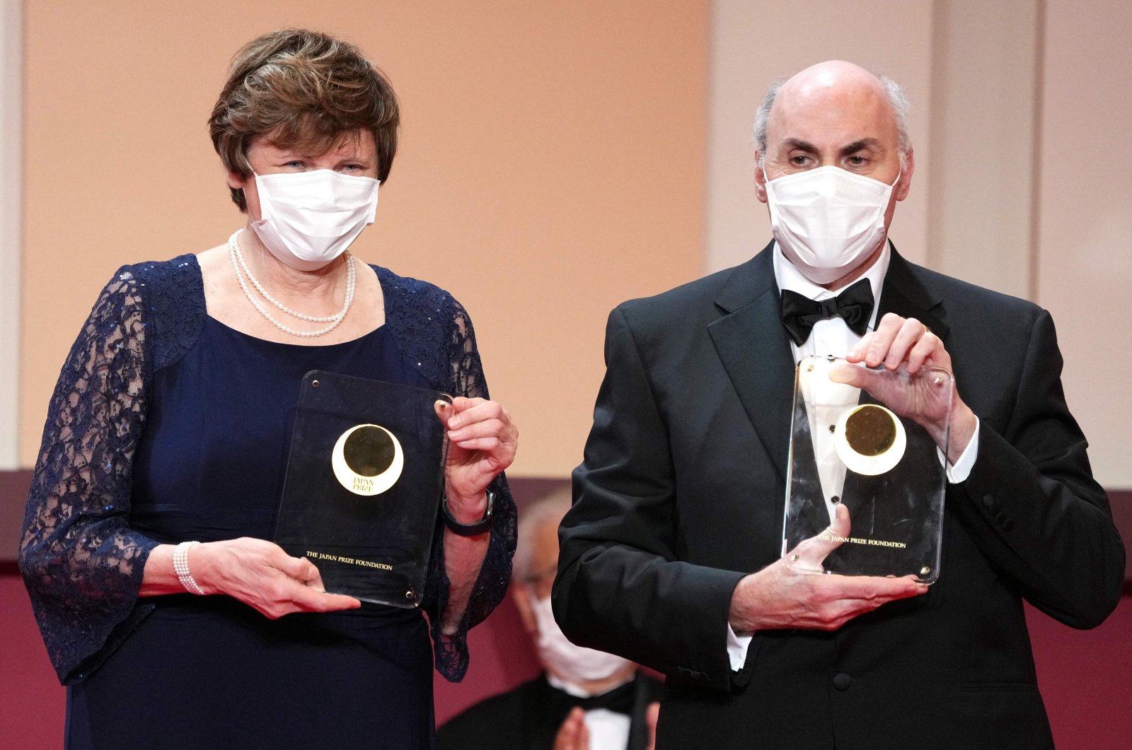 Japan Prize 2022 Laureates Hungarian-American biochemist Katalin Kariko (L) and American physician-scientist Drew Weissman pose with their trophy during the Japan Prize presentation ceremony in Tokyo on April 13, 2022. (AFP Photo)