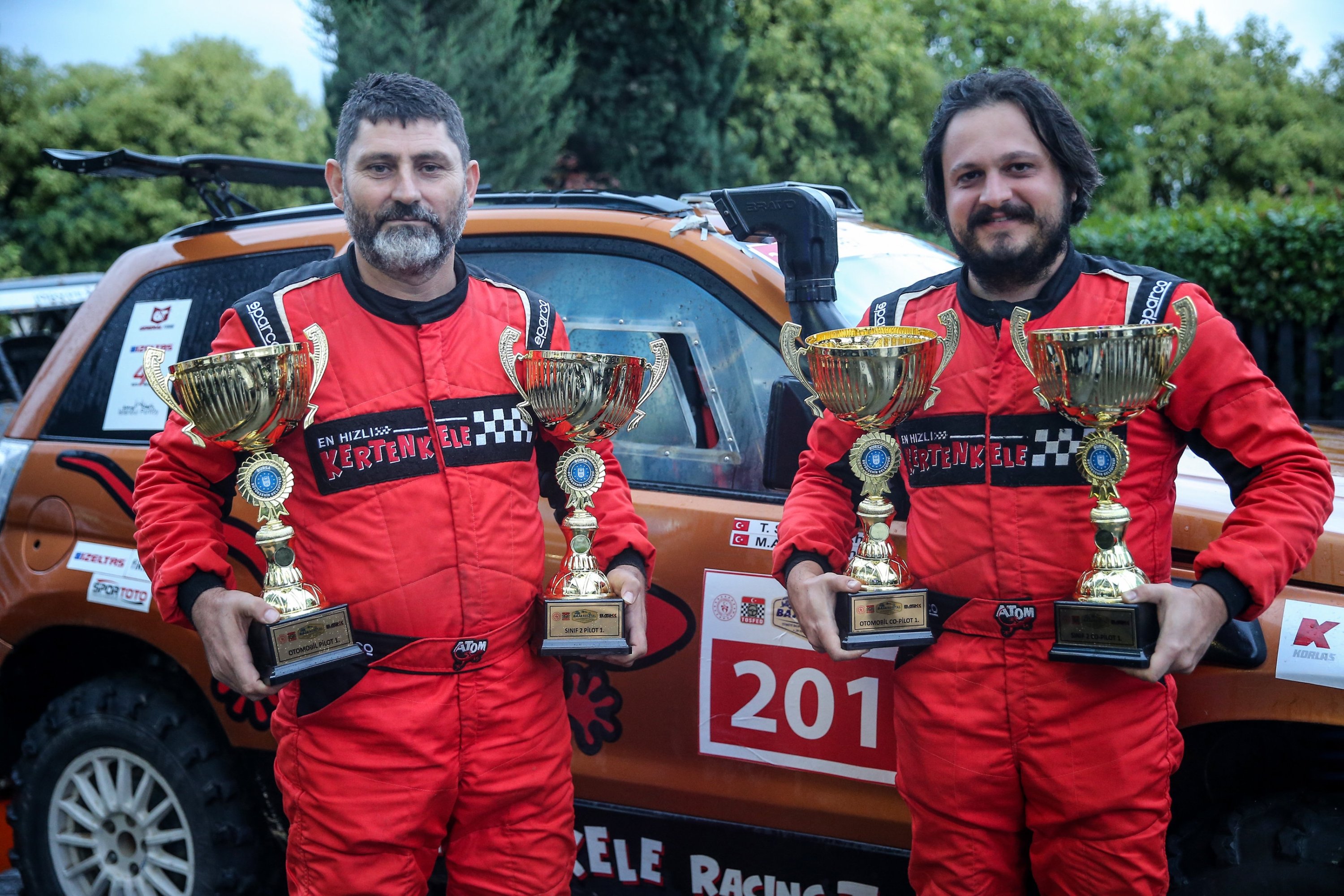 Turkish driver Murat Kamil Altun (L) poses for a photo with his co-pilot Tuvana Sayar at the Türkiye Baja Championship's second leg, the 