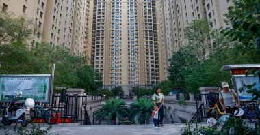 People walk along a China Evergrande residential area in Beijing, China, Sept. 18, 2023. (EPA Photo)