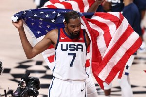 Team USA's Kevin Durant holds a flag after the game against the France Men's National Team during the Gold Medal Game of the 2020 Tokyo Olympics, at the Super Saitama Arena, Tokyo, Japan, Aug. 7, 2021. (Getty Images Photo)