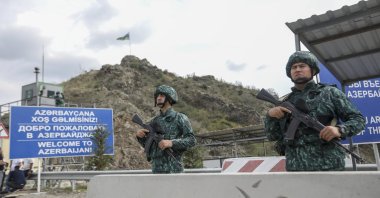 Azerbaijani servicepeople guard the Lachin checkpoint on the in Azerbaijan, Oct. 1, 2023. (AP Photo)