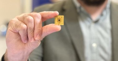 Scientists hold a sensor chip developed to detect food freshness, Istanbul, Türkiye, Oct. 3, 2023. (DHA Photo)