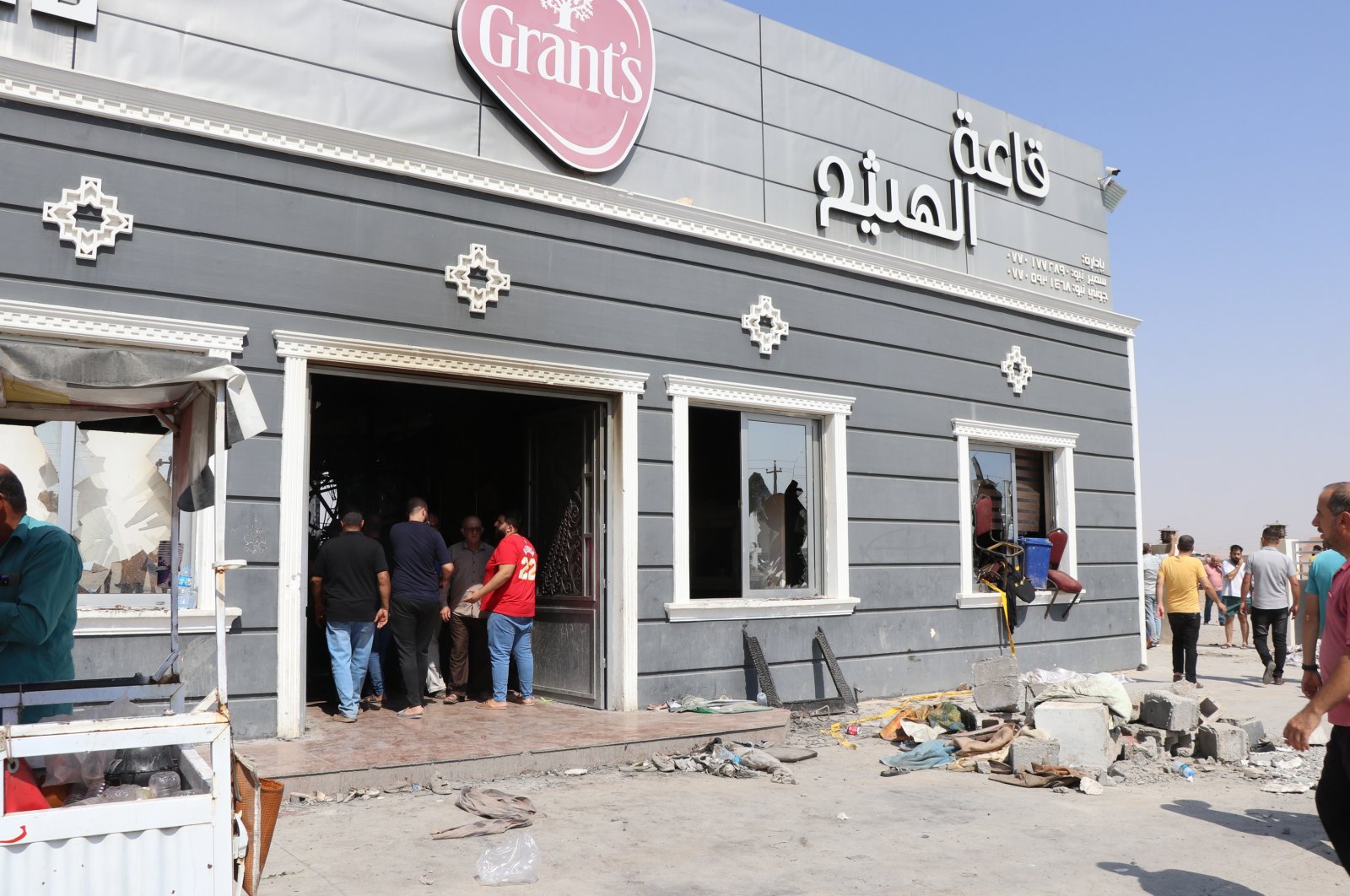 Iraqis inspect the scene the morning after a fire broke out at a wedding hall in Hamdaniya town, Iraq, Sept. 27, 2023. (EPA Photo)