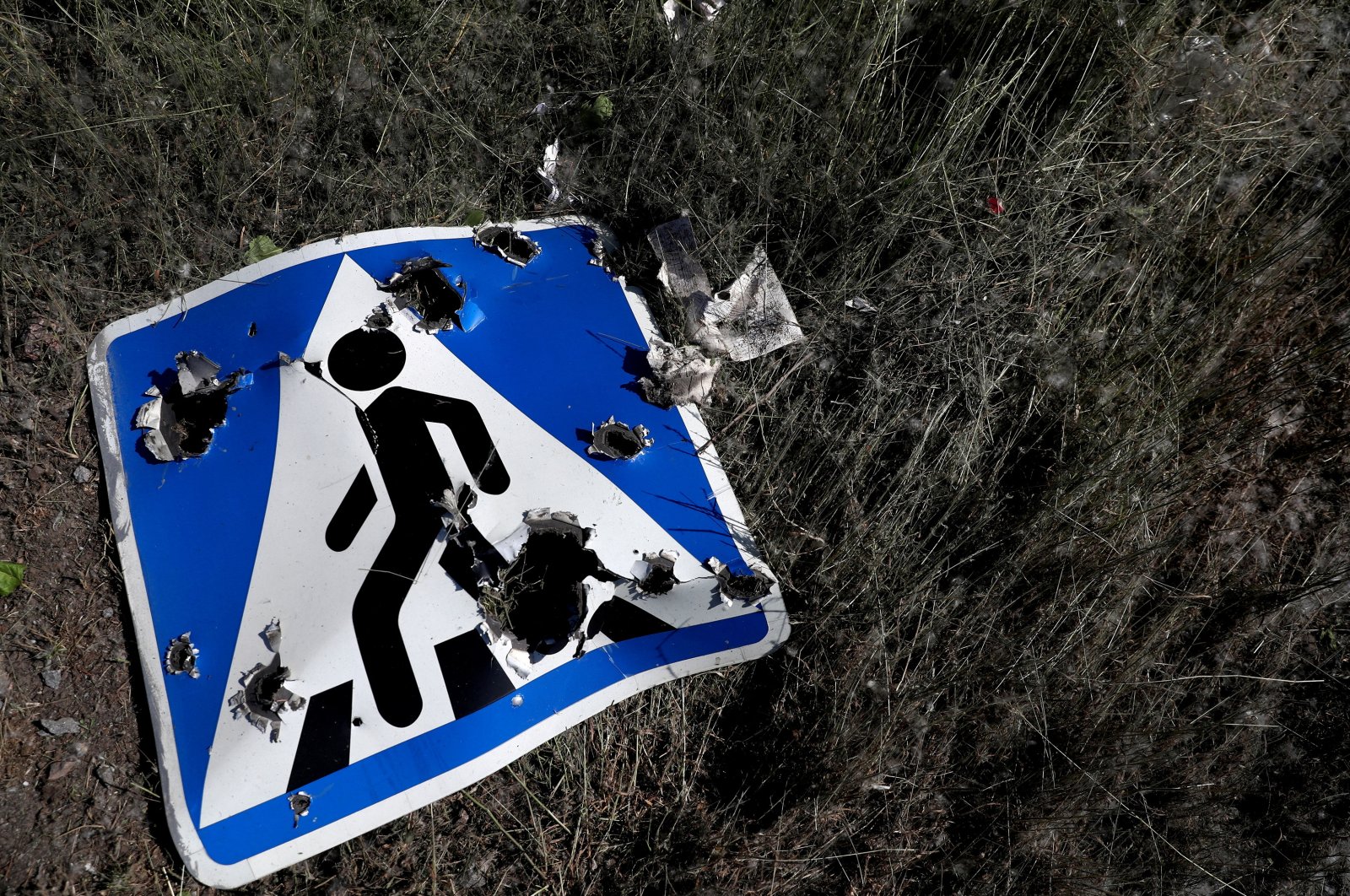 A road sign damaged by cluster munition is seen on the outskirts of Kharkiv, Ukraine, June 10, 2022. (Reuters Photo)