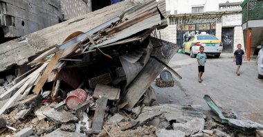 Palestinian children walk by a damaged building following an Israeli raid in Tulkarm, Israeli-occupied West Bank, Sept. 24, 2023. (Reuters Photo)