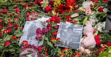 Photographs of people who died in the attack among carnations and wreaths left in memory of victims, in Istanbul, Türkiye, Nov. 15, 2022. (Shutterstock Photo)