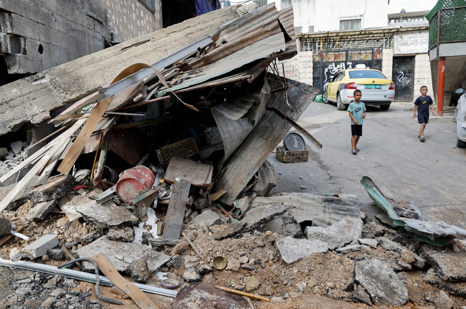 Palestinian children walk by a damaged building following an Israeli raid in Tulkarm, Israeli-occupied West Bank, Sept. 24, 2023. (Reuters Photo)