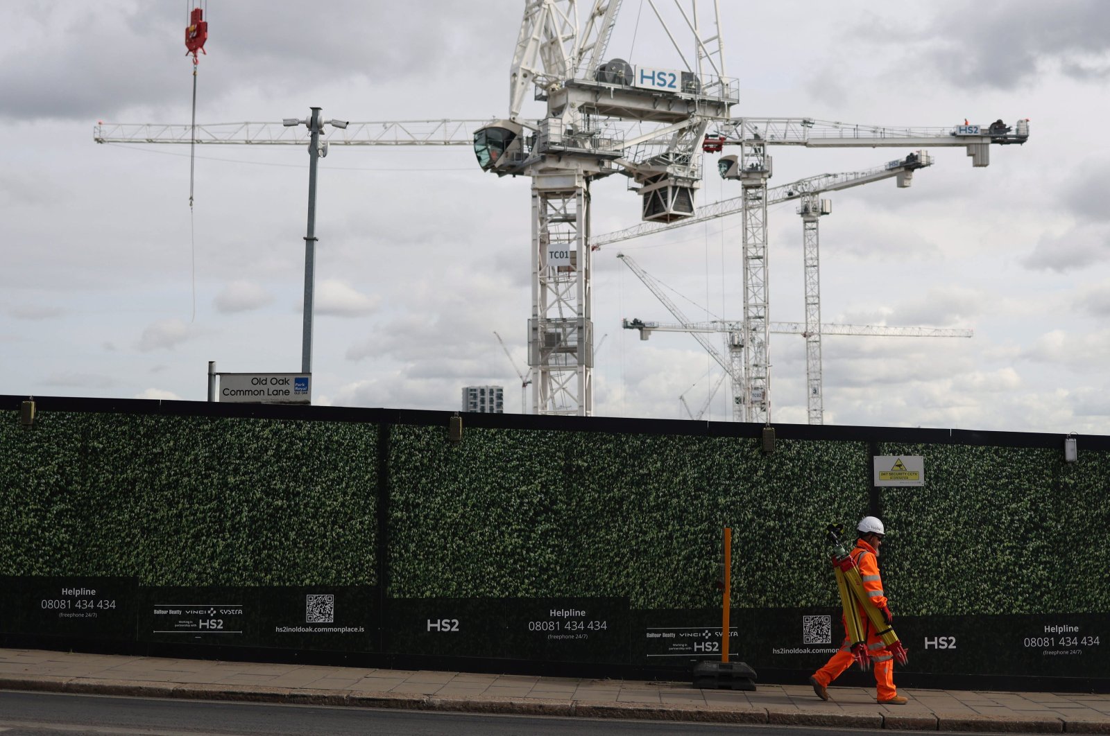 A worker passes cranes as construction takes place for the transport project HS2 at the Old Oak Common site in London, Britain, Oct. 4, 2023. (EPA Photo)