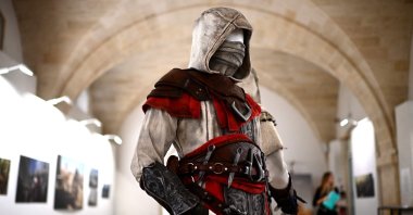 The costume of a character from Ubisoft&#039;s forthcoming video game &quot;Assassin&#039;s Creed Mirage&quot; created by artist Rick Boer, on display at an exhibition in Bordeaux, southwestern France, Oct. 3, 2023. (AFP Photo)