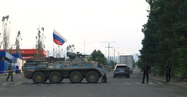 Azerbaijani police patrol next to a Russian peacekeeper vehicle at a checkpoint along the road leading to Khankendi, Azerbaijan, Oct. 2, 2023. (AFP Photo)