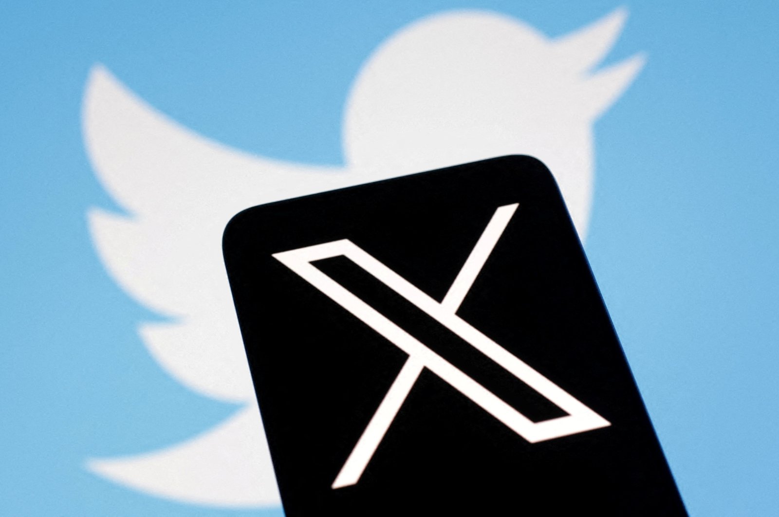 The logo for social media platform X, following the rebranding of Twitter, is seen covering the old logo in this illustration taken on July 24, 2023. (Reuters Photo)