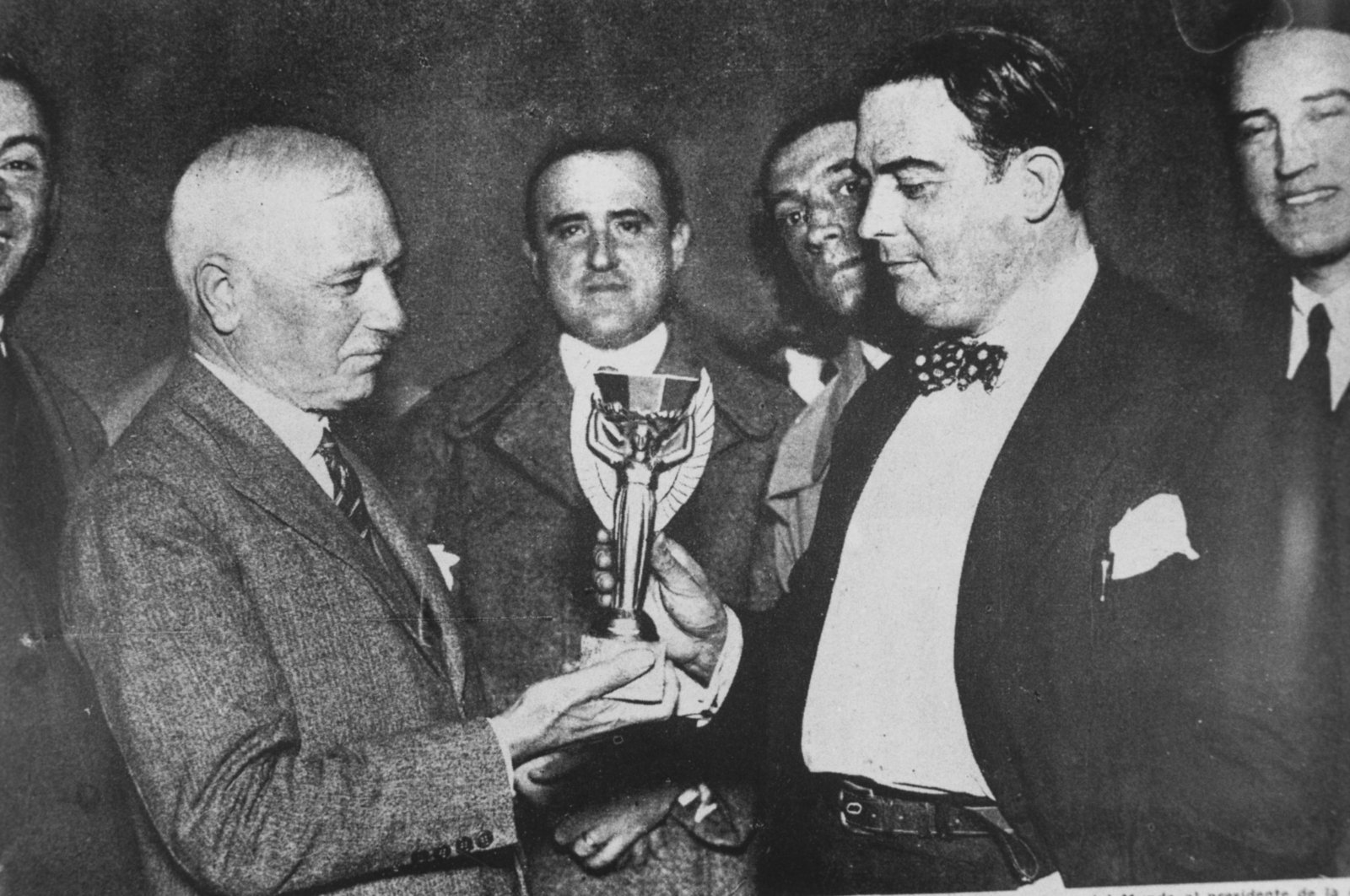 Jules Rimet, president of FIFA, presents the first World Cup trophy (the Jules Rimet Trophy) to Dr Paul Jude, the president of the Uruguayan Football Association, after Uruguay beat Argentina 4-2 in the first ever World Cup final, Montevideo, Uruguay, July 30, 1930. (Getty Images Photo)
