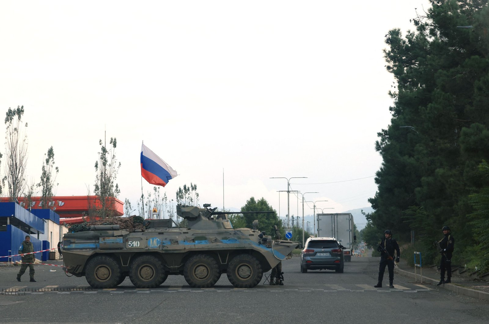 Azerbaijani police patrol next to a Russian peacekeeper vehicle at a checkpoint along the road leading to Khankendi, Azerbaijan, Oct. 2, 2023. (AFP Photo)
