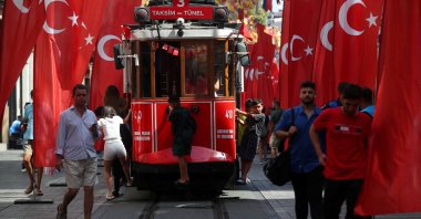 People stroll at the main shopping and pedestrian street of Istiklal which is decorated with Turkish flags to mark Victory Day, Istanbul, Türkiye, Aug. 30, 2023. (Reuters Photo)