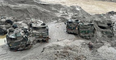 Trucks buried in mud are seen in an area affected by flood in Sikkim, India, Oct. 5, 2023. (Reuters Photo)