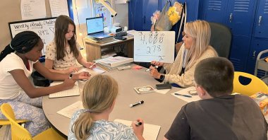 Piedmont Elementary School math teacher Cassie Holbrooks helps a small group of fourth-grade students with a three-digit subtraction problem in Piedmont, Alabama, U.S., Aug. 31, 2023. (AP Photo)