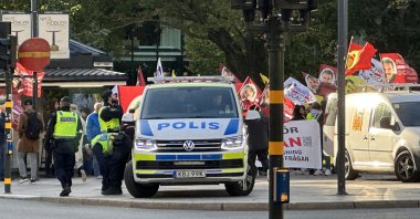 PKK/YPG supporters wave flags of the terrorist group as they march to the Swedish Parliament under police supervision in Stockholm, Sweden, Oct. 7, 2023. (AA Photo)