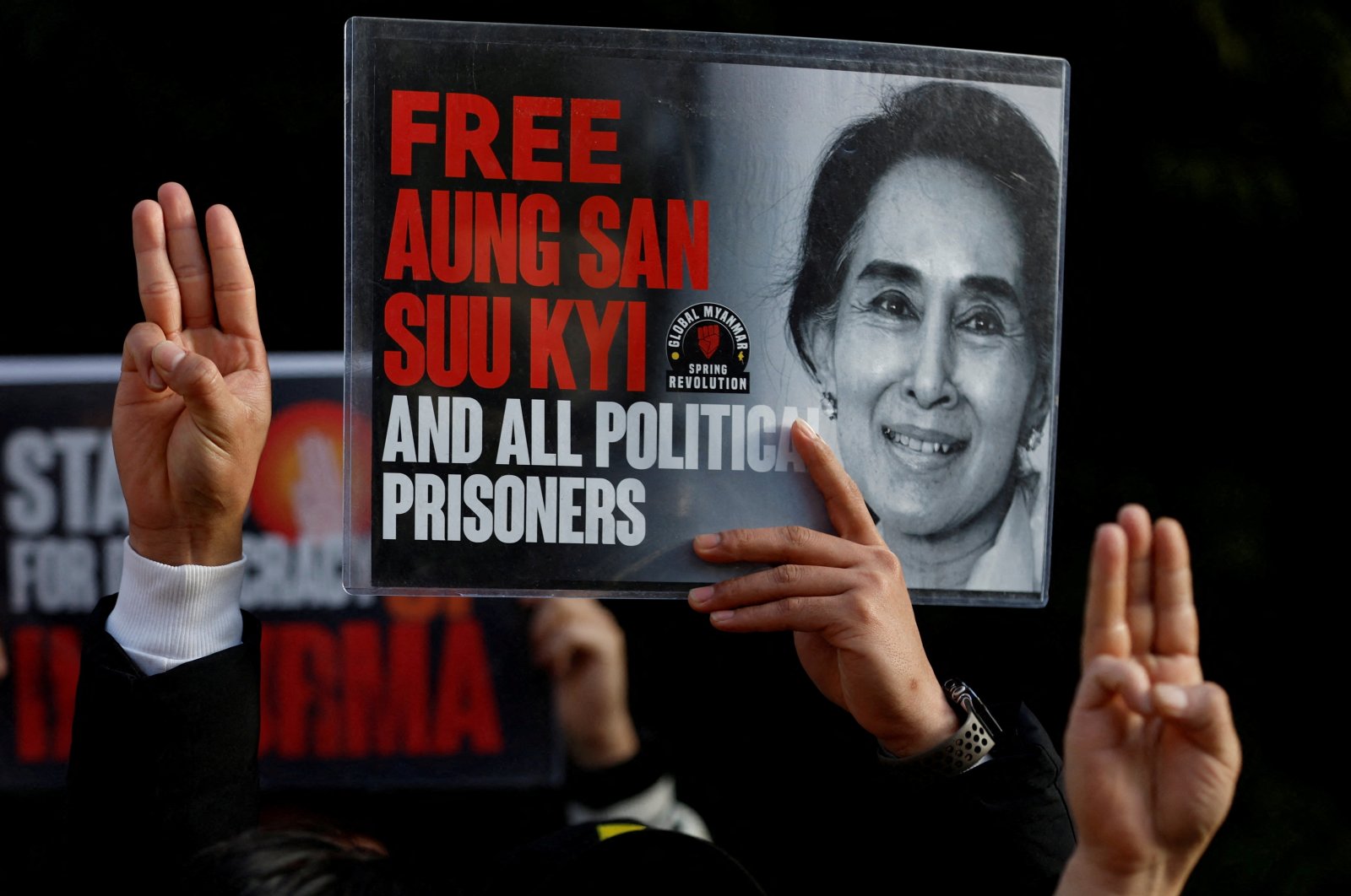 Myanmar protesters residing in Japan show off the portrait of Aung San Suu Kyi and raise three-finger salutes, during a rally to mark the second anniversary of Myanmar&#039;s 2021 military coup, outside the Embassy of Myanmar in Tokyo, Japan, Feb. 1, 2023. (Reuters Photo)