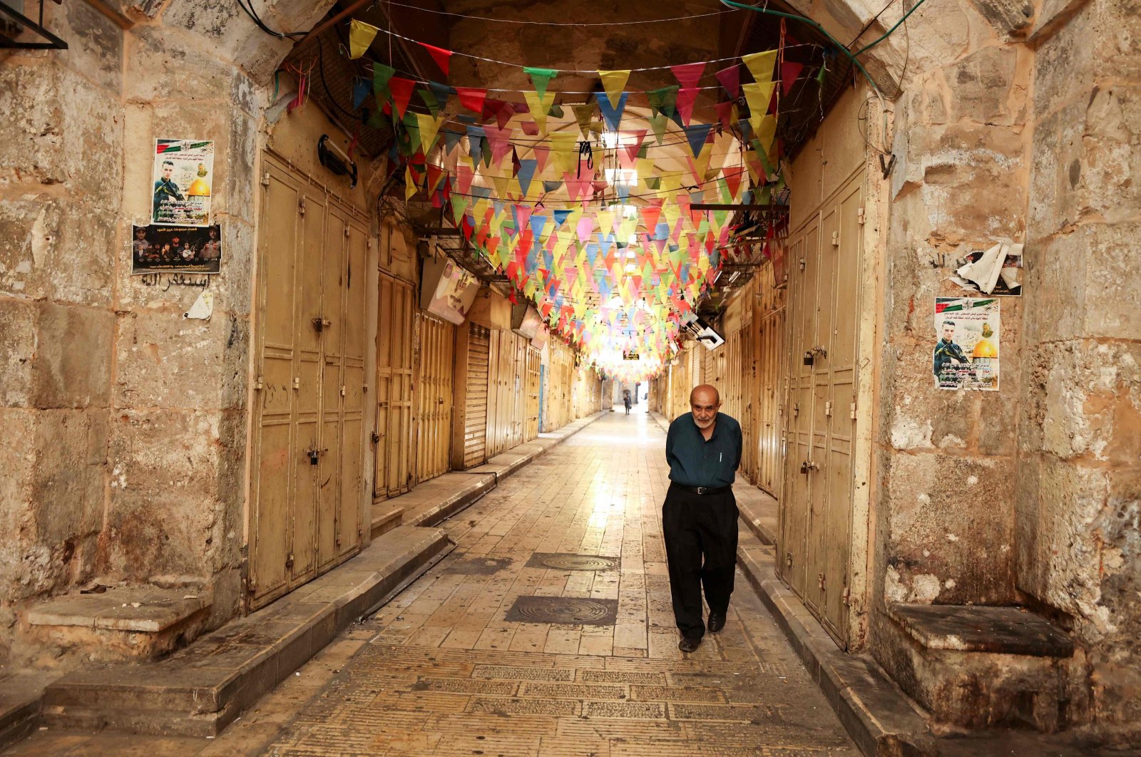 A man walks past closed shops in a market area during a general strike in Nablus, occupied West Bank, Palestine, Oct. 8, 2023. (AFP Photo)