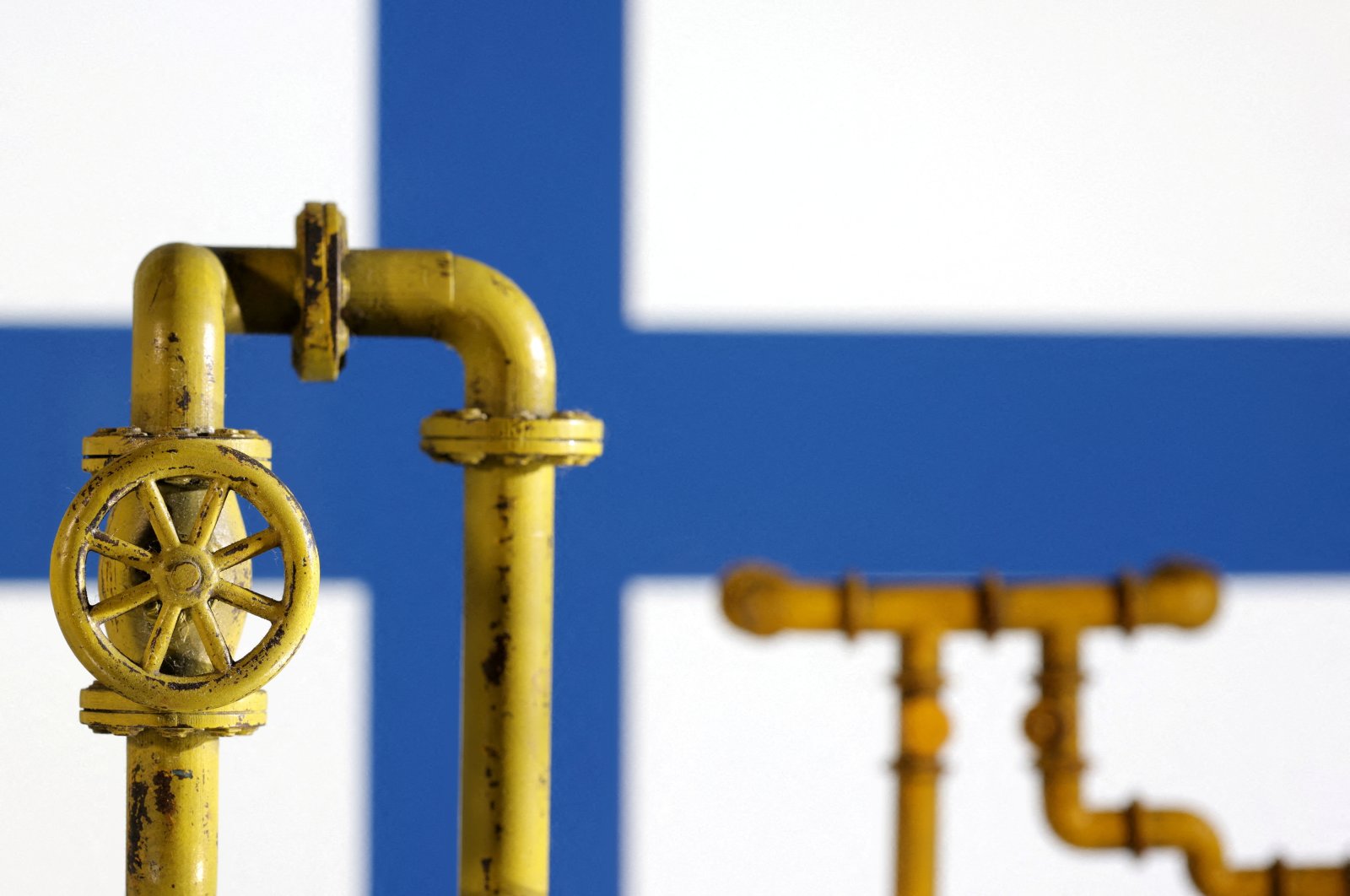 Model of natural gas pipeline and Finland flag, July 18, 2022. (Reuters Photo)