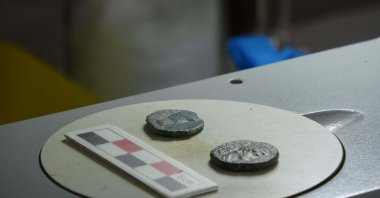 Two 2,000-year-old bronze coins found during excavations in the ancient city of Alexandria Troas, Çanakkale, Türkiye, Oct. 9, 2023. (DHA Photo)