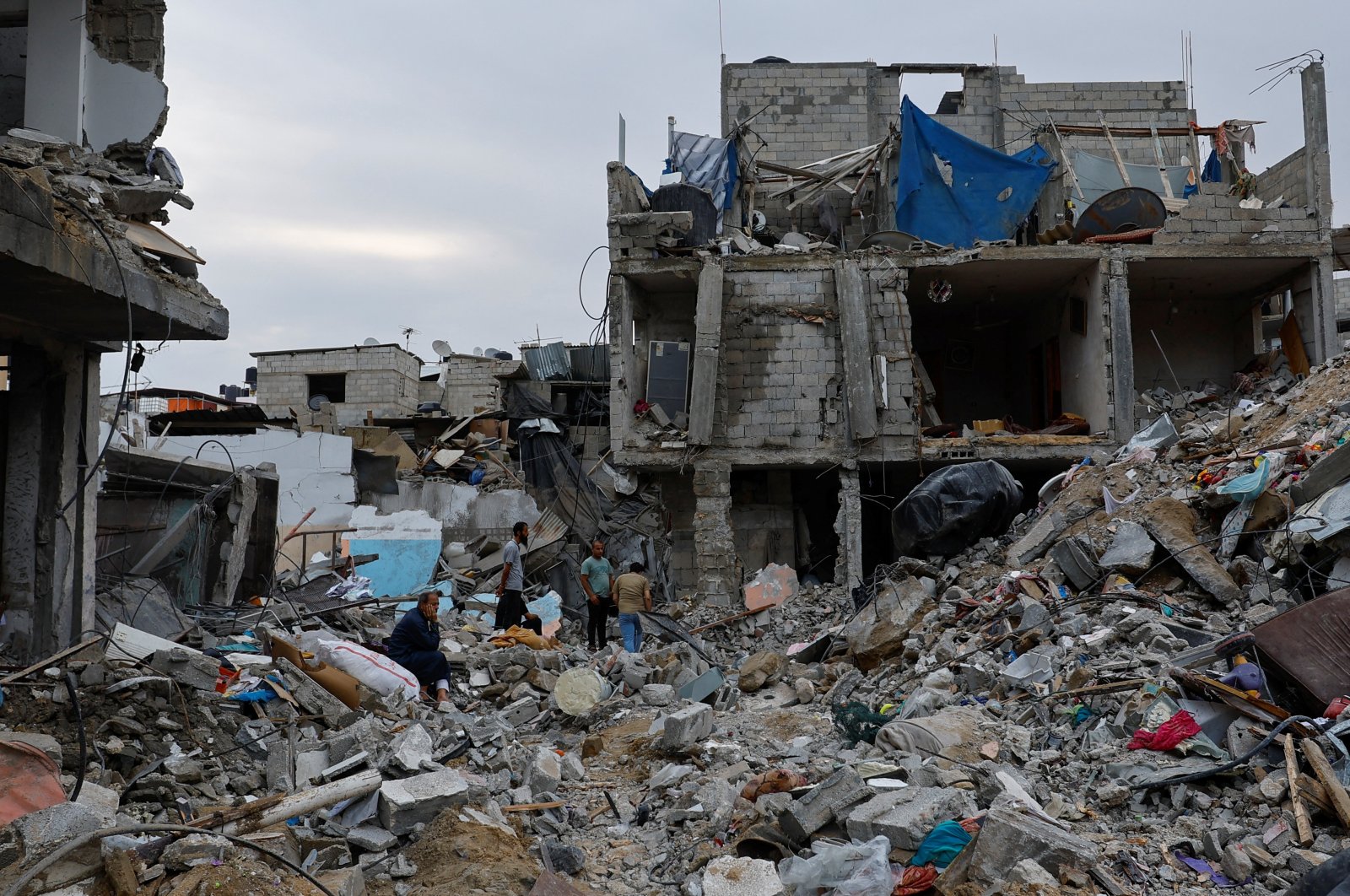 Palestinians inspect buildings destroyed in Israeli strikes, in Rafah, southern Gaza Strip, Palestine, Oct. 9, 2023. (Reuters Photo)