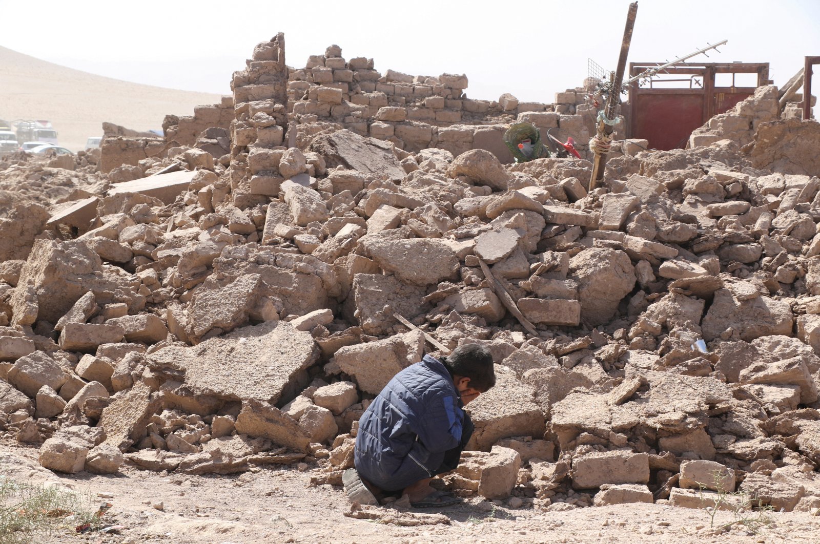 A boy cries as he sits next to debris, in the aftermath of an earthquake in the district of Zendeh Jan, Herat, Afghanistan, Oct. 8, 2023. (Reuters Photo)
