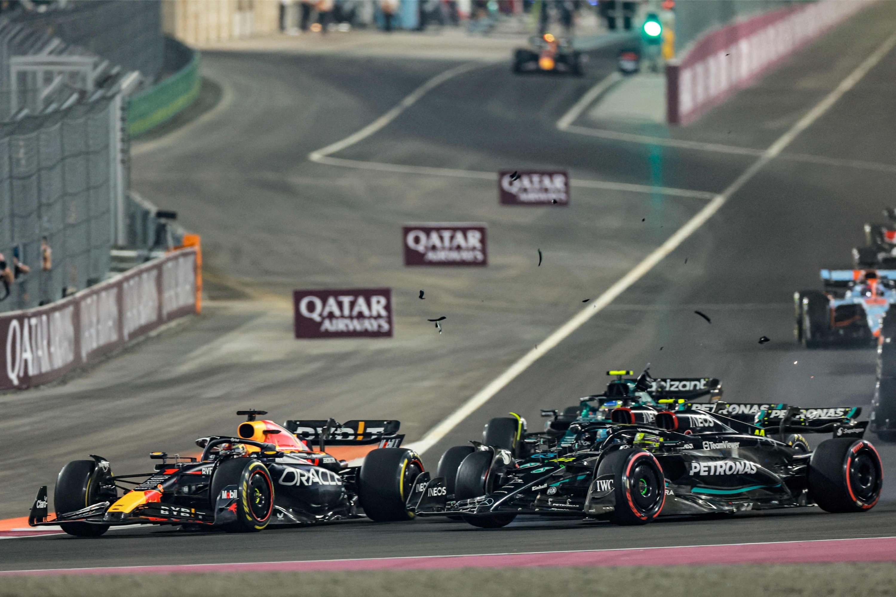 Mercedes' British driver George Russell (C) and Mercedes' British driver Lewis Hamilton (R) collide during the Qatari Formula One Grand Prix at Lusail International Circuit, Lusail, Qatar, Oct. 8, 2023. (AFP Photo)