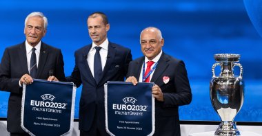 UEFA President Aleksander Ceferin (C) shows the name of Italy and Türkiye elected to host the Euro 2032 fooball tournament with Gabriele Gravina (L), president of the Italian Football Federation (FIGC) and Mehmet Büyükekşi (R), president of the Turkish Football Federation (TFF) during the the UEFA EURO 2028 and 2032 hosts announcement ceremony after the UEFA Executive Committee meeting at its headquarters, Nyon, Switzerland, Oct. 10, 2023. (EPA Photo)