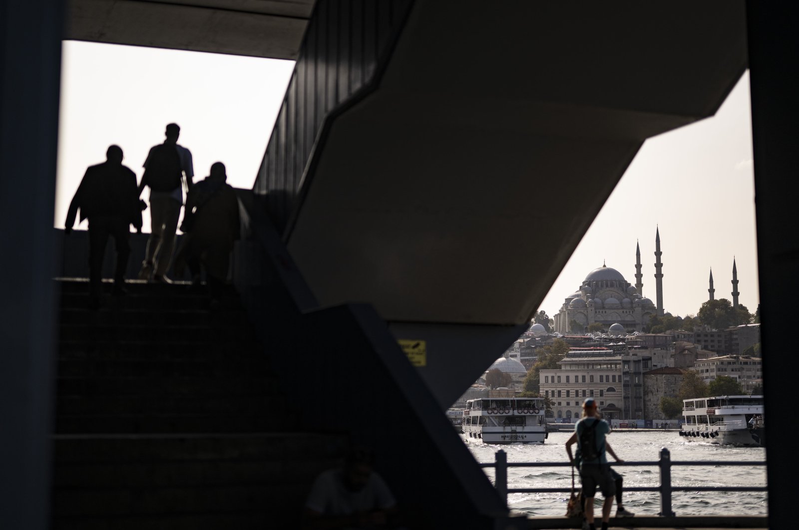 People walking on stairs with the backdrop of Eminönü New Mosque, Istanbul, Türkiye, Oct. 4, 2023. (AA Photo)