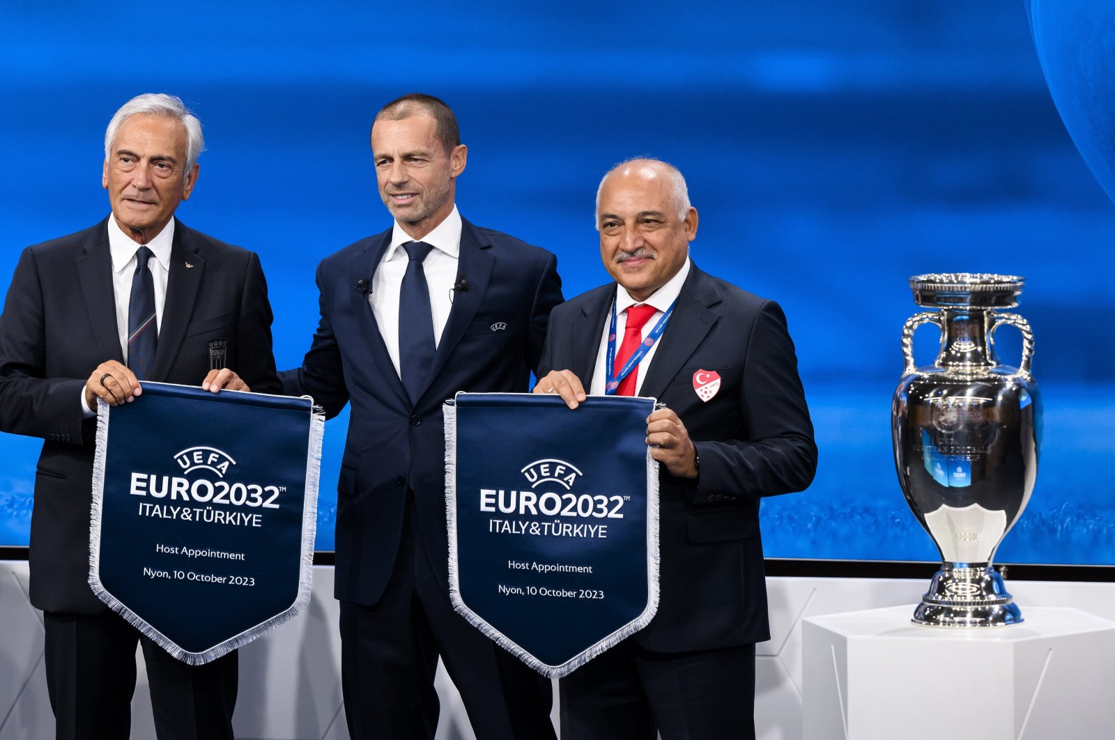 UEFA President Aleksander Ceferin (C) shows the name of Italy and Türkiye elected to host the Euro 2032 fooball tournament with Gabriele Gravina (L), president of the Italian Football Federation (FIGC) and Mehmet Büyükekşi (R), president of the Turkish Football Federation (TFF) during the the UEFA EURO 2028 and 2032 hosts announcement ceremony after the UEFA Executive Committee meeting at its headquarters, Nyon, Switzerland, Oct. 10, 2023. (EPA Photo)
