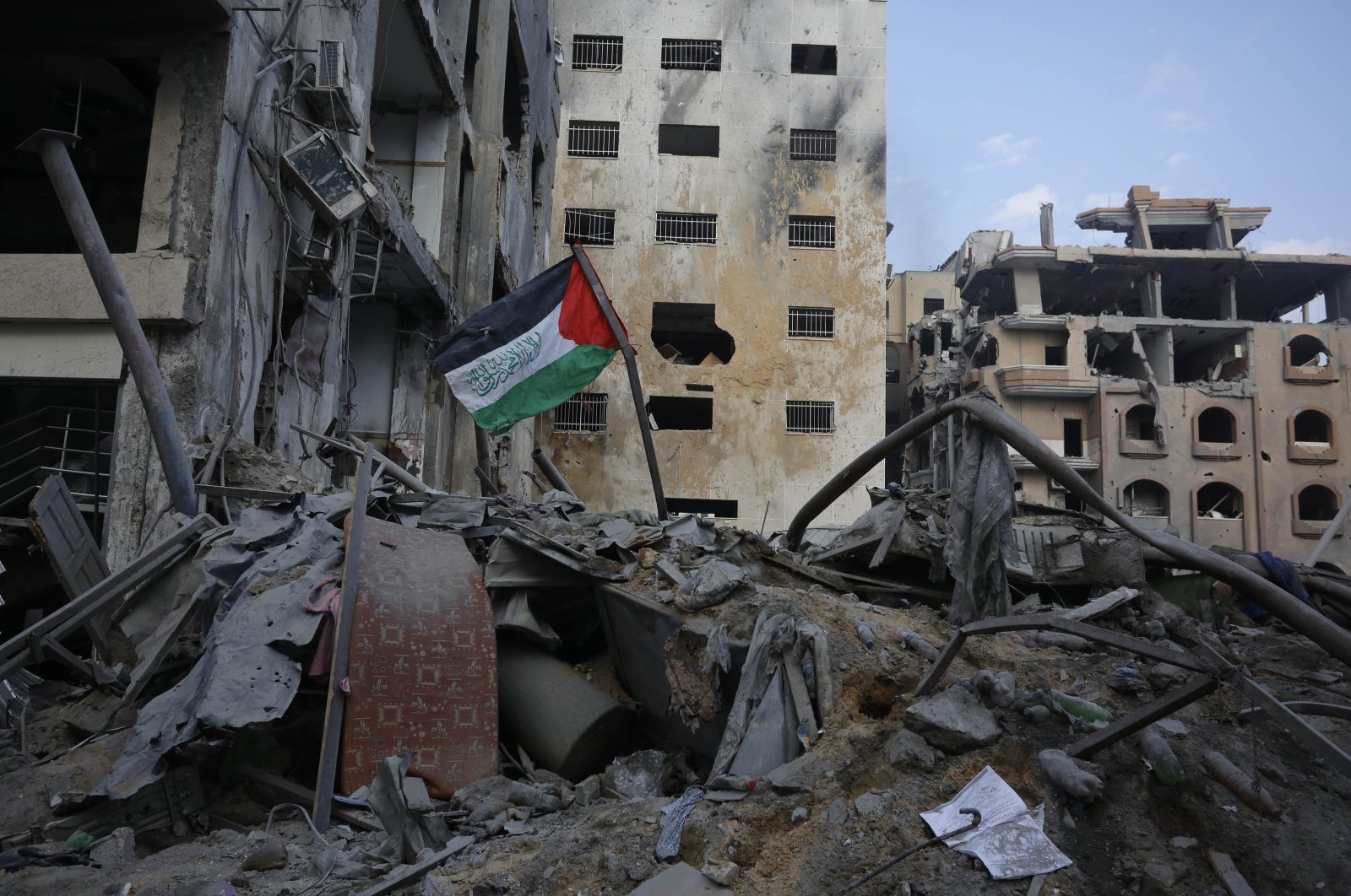 A Palestinian flag is seen on the rubble of a building destroyed in Israeli airstrikes in Gaza City&#039;s Rimal district, Palestine, Oct. 10, 2023. (AFP Photo)