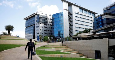 A man walks past office towers at a business park also housing high-tech companies, at Ofer Park in Petah Tikva, Israel, Aug. 27, 2020. (Reuters Photo)