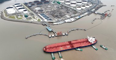 An aerial view shows tugboats helping a crude oil tanker to berth at an oil terminal, off Waidiao Island in Zhoushan, Zhejiang province, China, July 18, 2022. (Reuters Photo)
