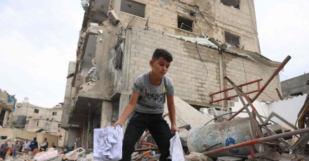 A Palestinian boy looks amid the rubble of a leveled building following overnight Israeli airstrikes on Rafah in the southern Gaza Strip, Palestine, Oct. 9, 2023. (AFP Photo)