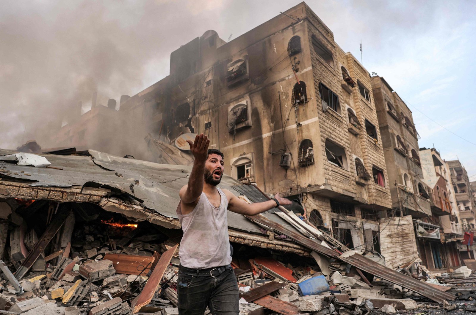A man reacts outside a collapsed building following Israeli bombardment in Gaza City, Palestine, Oct. 11, 2023. (AFP Photo)