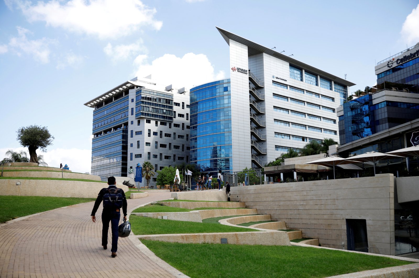 A man walks past office towers at a business park also housing high-tech companies, at Ofer Park in Petah Tikva, Israel, Aug. 27, 2020. (Reuters Photo)