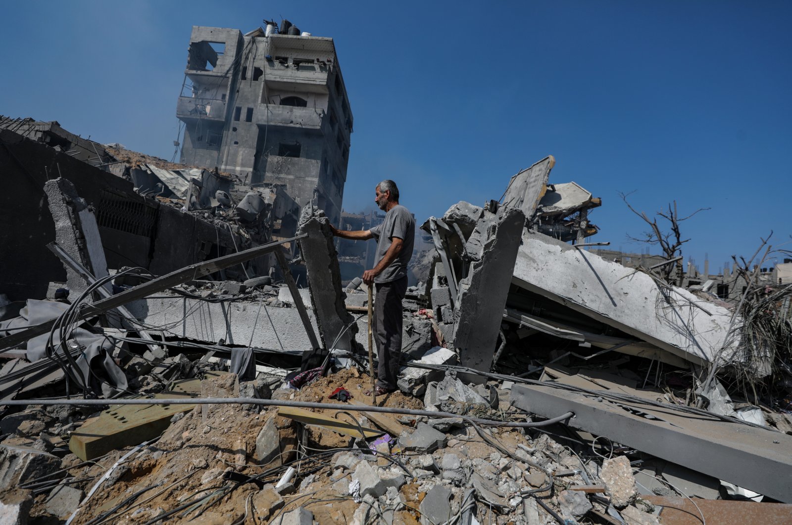 A Palestinian man inspects a destroyed house in the Al-Ramal neighborhood following an Israeli air strike in Gaza City, Palestine, Oct. 10, 2023. (EPA Photo)
