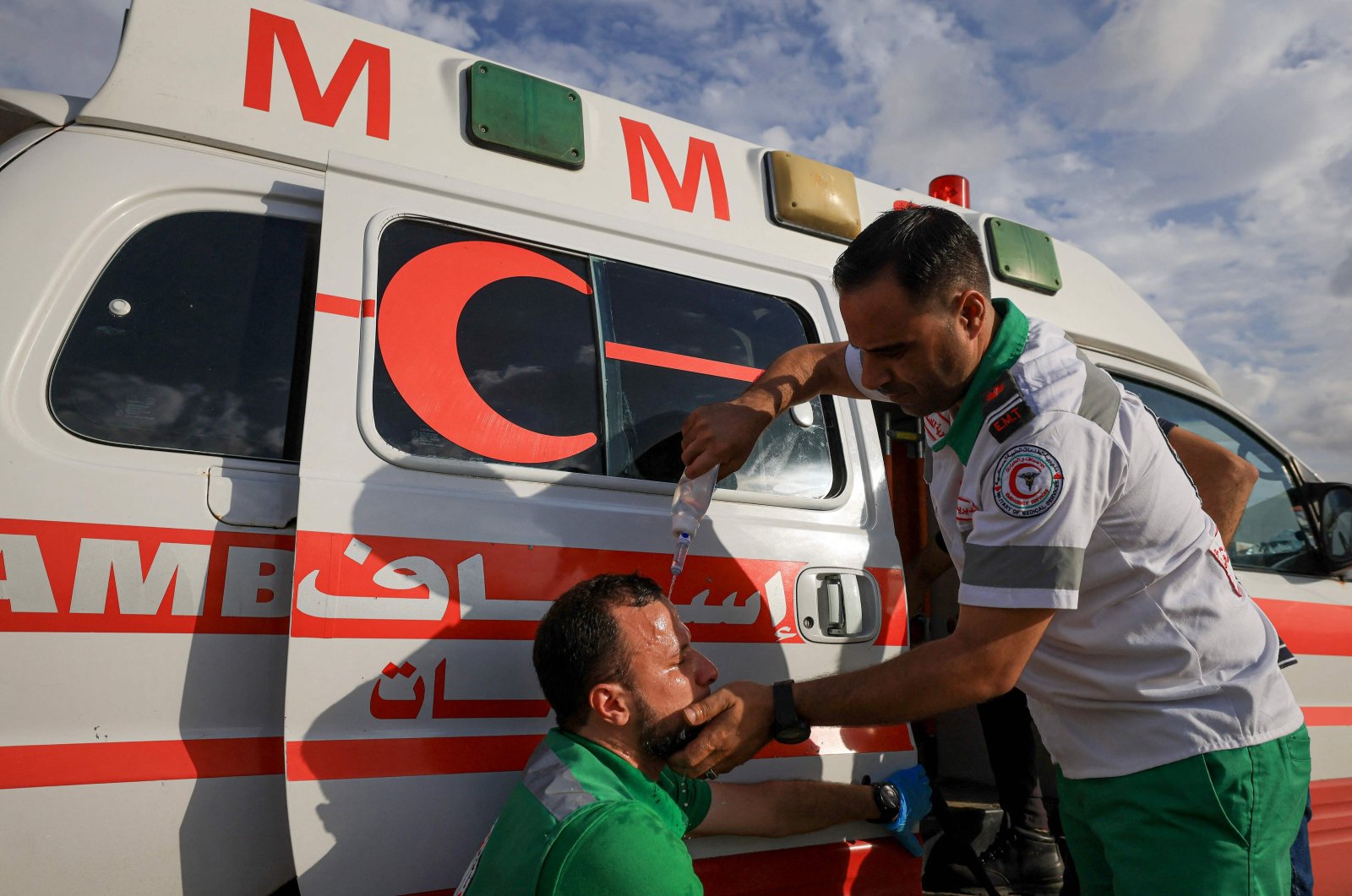 A Palestinian Red Crescent medic pours water on a protester&#039;s face during a demonstration along the border, east of Gaza City, to mark Israel&#039;s withdrawal from the Gaza Strip in 2005, Sept. 13, 2023. (AFP File Photo)