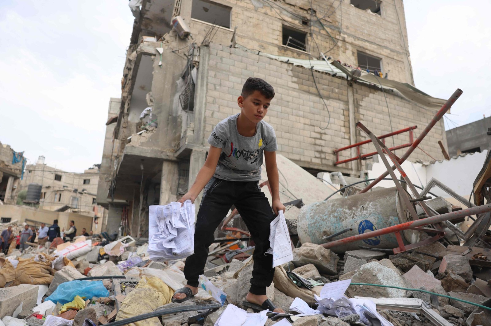 A Palestinian boy looks amid the rubble of a leveled building following overnight Israeli airstrikes on Rafah in the southern Gaza Strip, Palestine, Oct. 9, 2023. (AFP Photo)