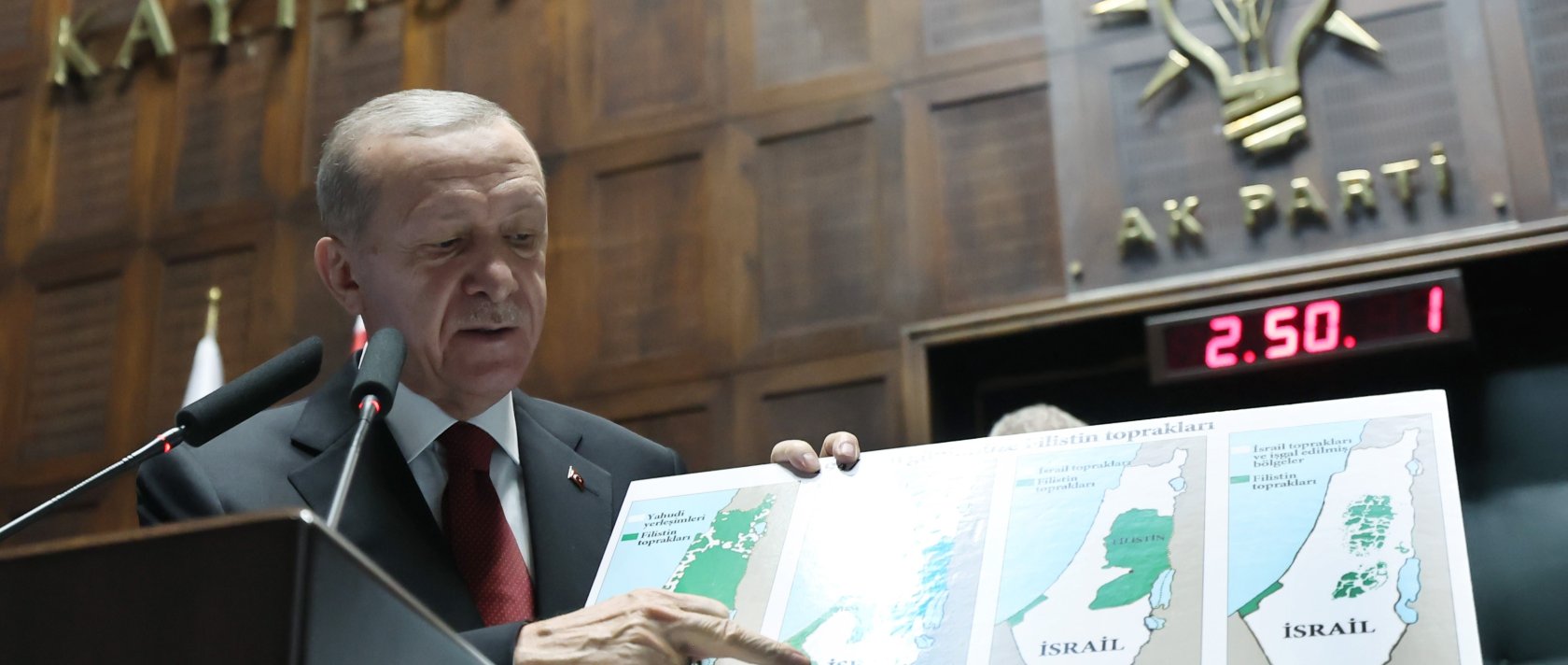 President Recep Tayyip Erdoğan holds a map showing Israel's occupation of Palestinian lands throughout the years during a Justice and Development Party (AK Party) parliamentary group meeting in Ankara, Türkiye, Oct. 11, 2023. (IHA Photo)