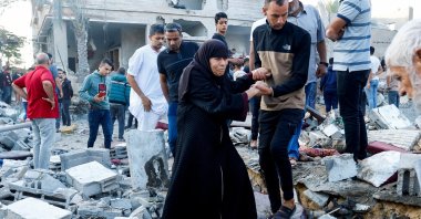 People walk on rubble in the aftermath of a strike amid the conflict with Israel in Khan Younis, in the southern Gaza Strip, Palestine, Oct.12, 2023. (Reuters Photo)