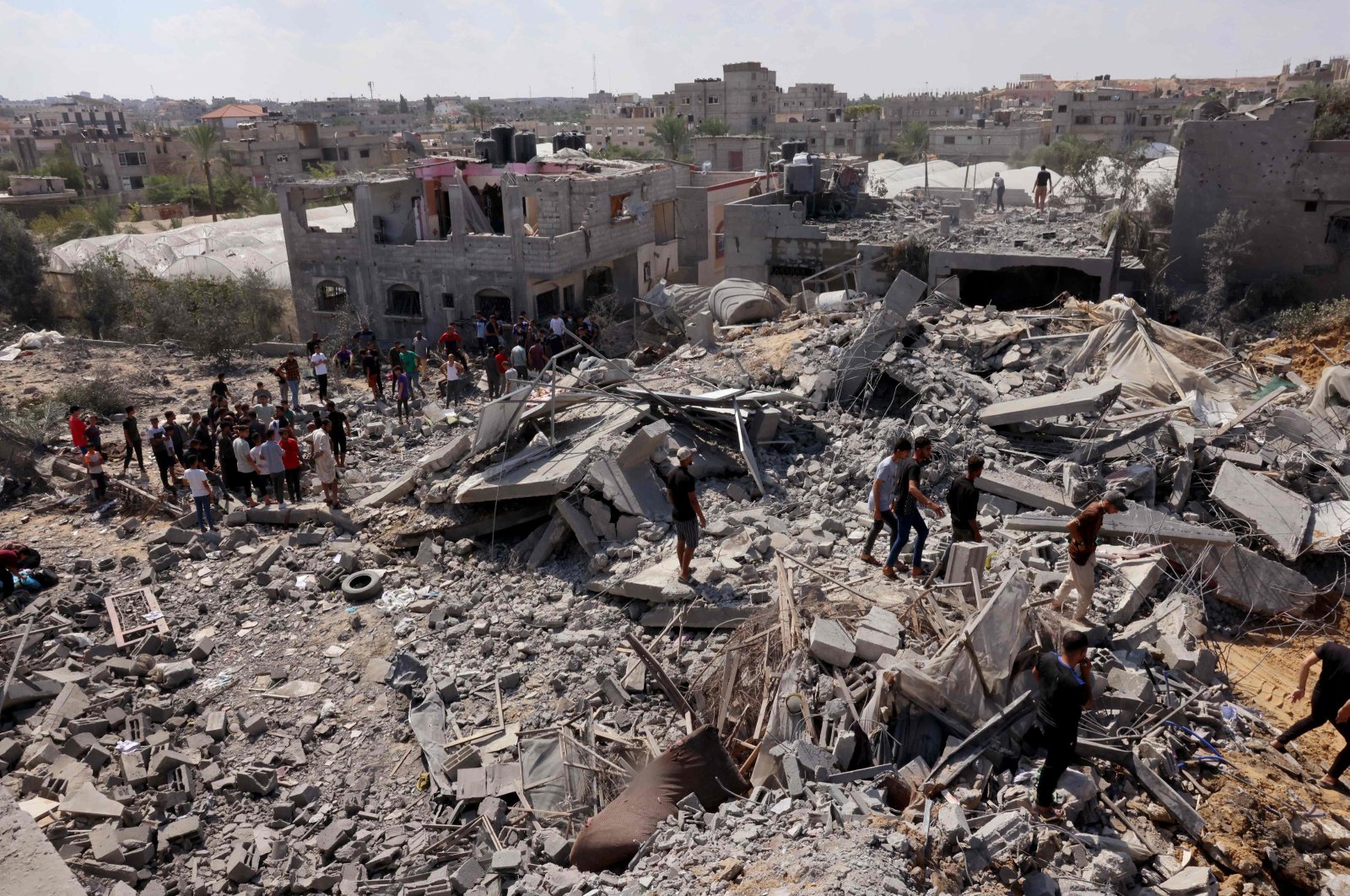 Palestinians search the rubble of destroyed buildings following an Israeli strike, in Rafah, Palestine, October 12, 2023. (AFP Photo) 