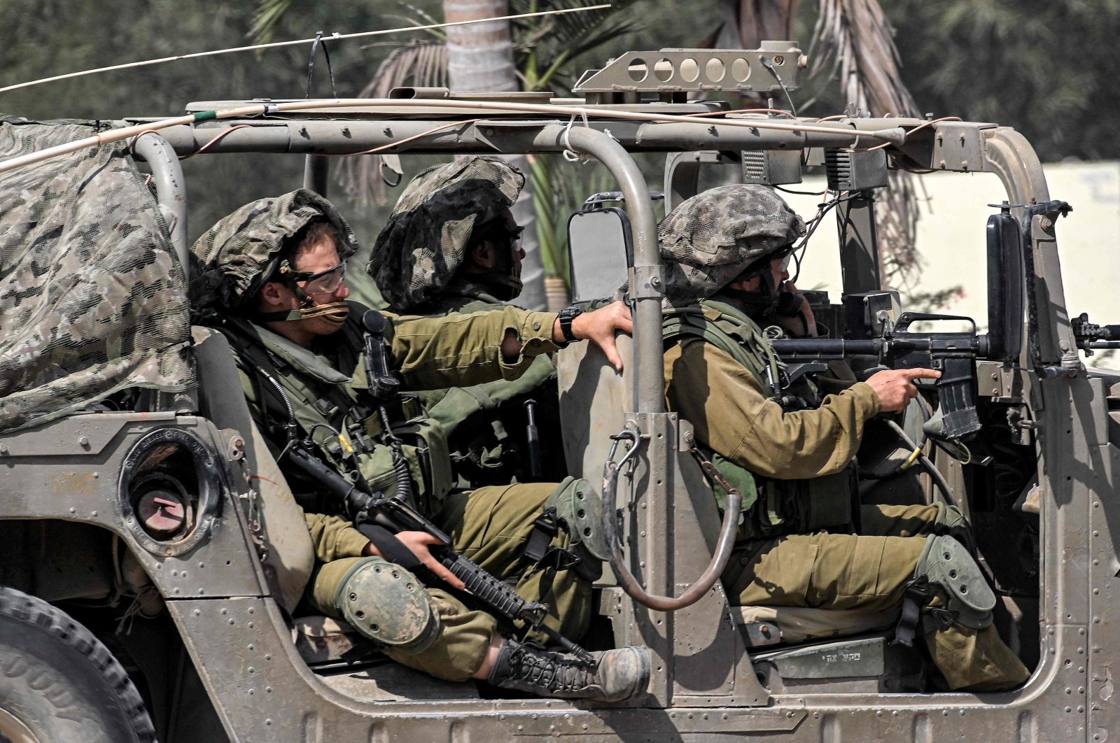 Israeli army soldiers sit in a humvee at a checkpoint near the border with the Gaza Strip, Sderot, Israel, Oct. 12, 2023. (AFP Photo)