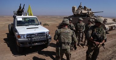 U.S. soldiers cluster as they conduct a joint military drill with PKK/YPG terrorists near the town of Qamishli in northeastern Hasakah province, Syria, Aug. 18, 2023. (AA Photo)
