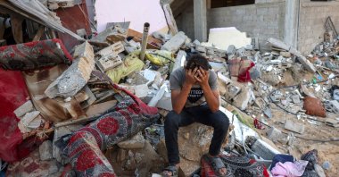 A Palestinian youth reacts as he sits on the rubble following an Israeli military strike on the Rafah refugee camp, in the southern Gaza Strip, Palestine, Oct. 15, 2023. (AFP Photo)