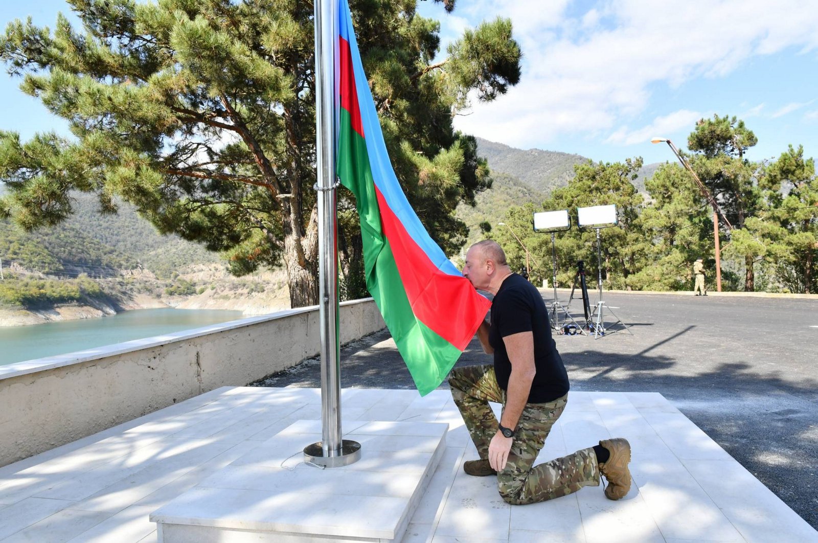 Azerbaijani President Ilham Aliyev kisses the flag before raising it near Sarsang Reservoir, Karabakh, Azerbaijan, Oct. 15, 2023. (AA Photo)